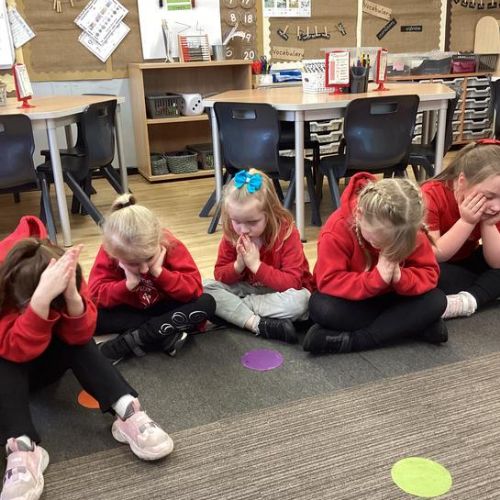 The children lead our Collective Worship by passing around a bowl of water and doing the sign of the cross, just like we do in Church.